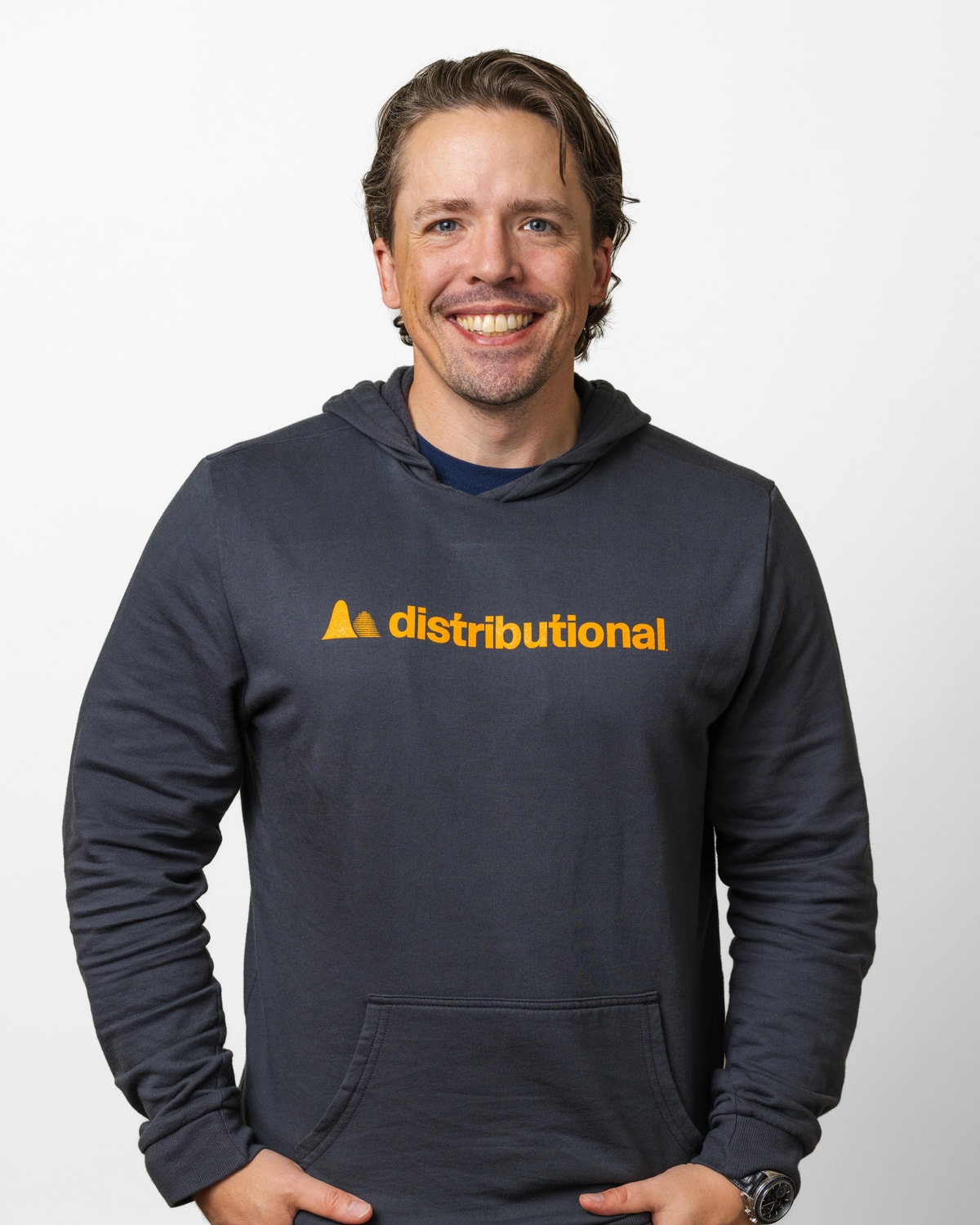Scott Clark, CEO, Distributional, headshot in a Distributional hoodie, hands in pockets, 4:5 portrait crop